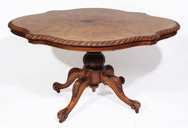 Appraisal: A VICTORIAN WALNUT LOO TABLE with shaped top with rope