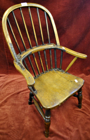 Appraisal: A th century child's elm Windsor chair the stick back