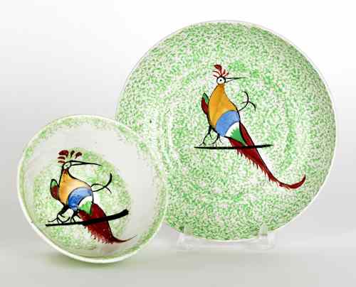 Appraisal: Green spatter cup and saucer th c with a peafowl