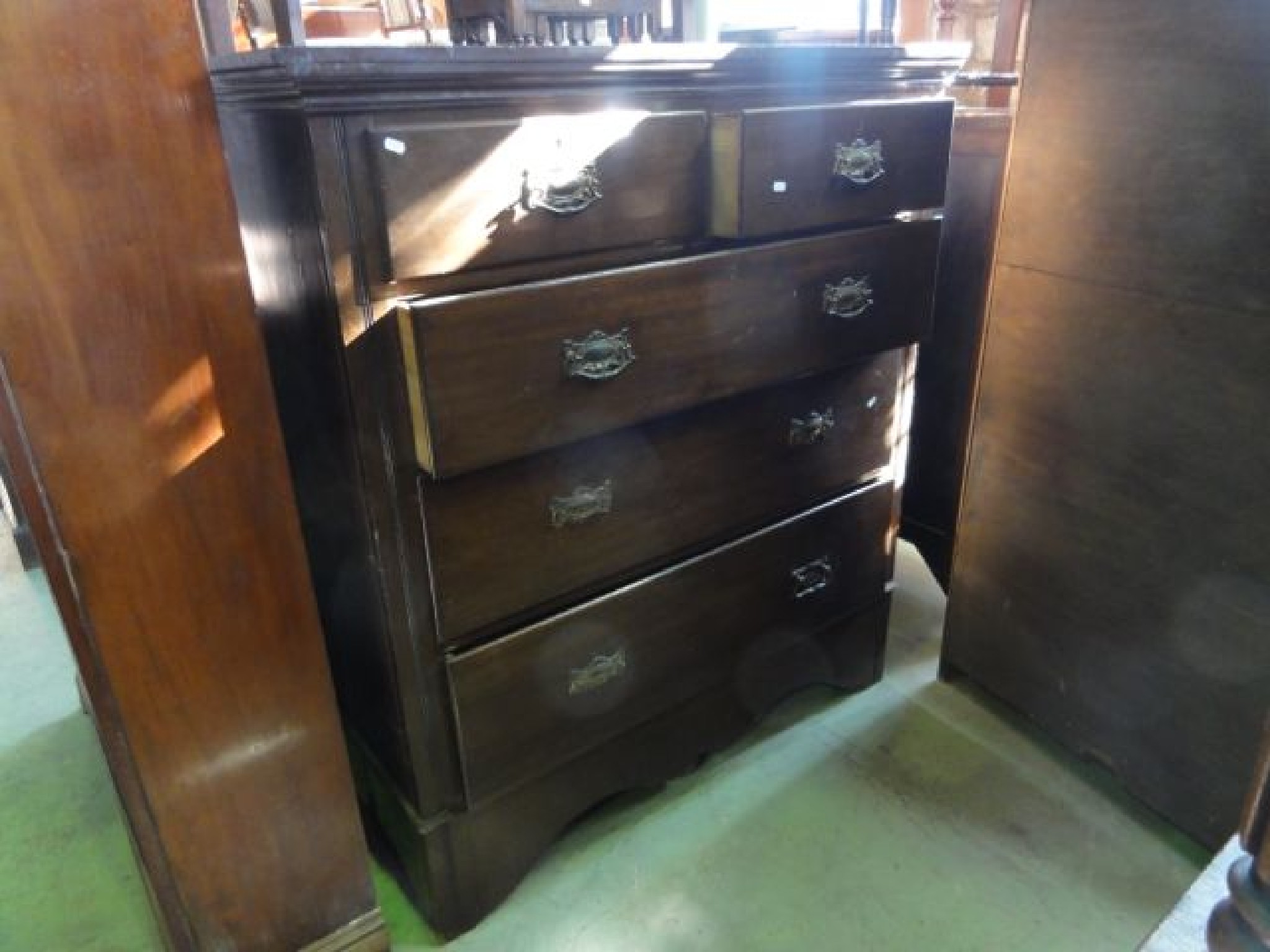 Appraisal: A substantial Edwardian walnut beroom chest of three long and