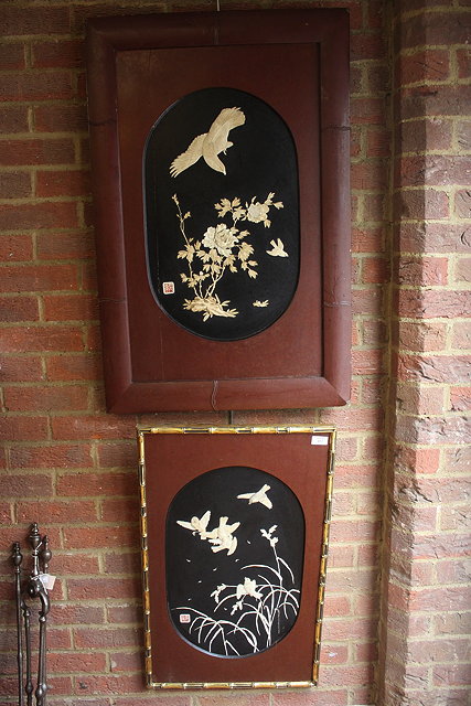 Appraisal: A PAIR OF JAPANESE IVORY AND EBONY WALL PLAQUES with