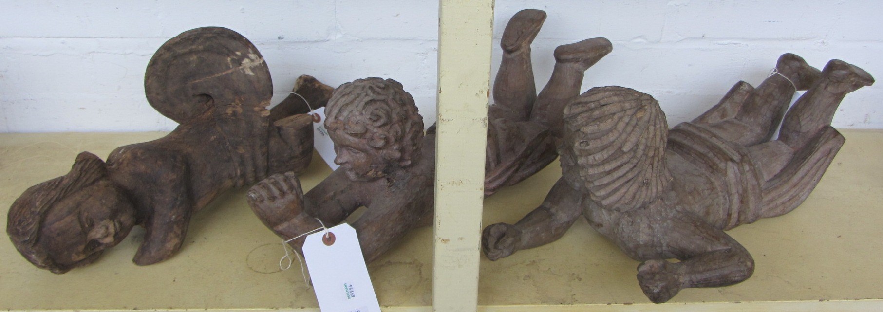 Appraisal: Three carved wooden cherub figures th century formerly papier mache