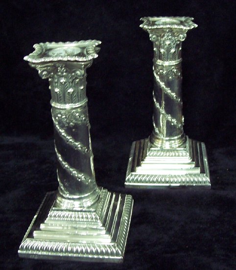 Appraisal: A pair of Corinthian column candlesticks spirally swagged with oak