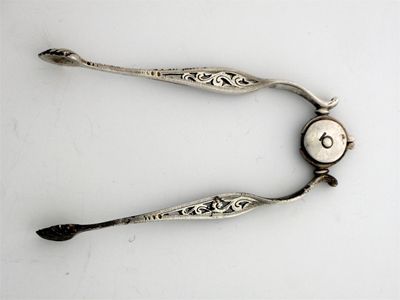 Appraisal: A pair of Victorian pierced sugar tongs with a 'spring'