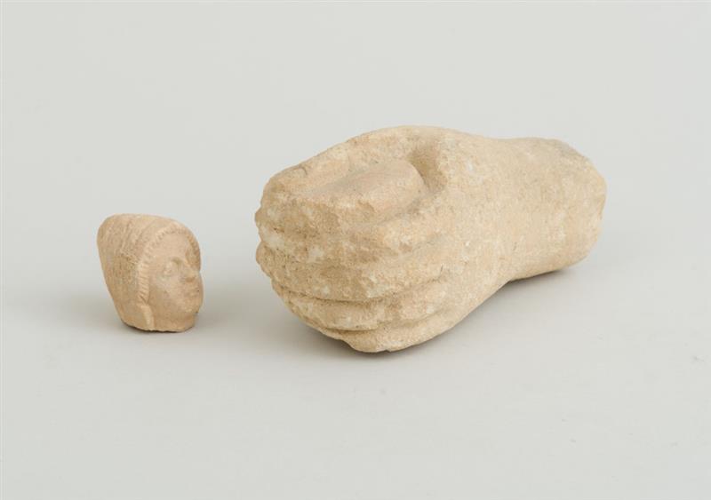 Appraisal: CYPRIOT CARVED LIMESTONE HEAD OF A MAN Together with a