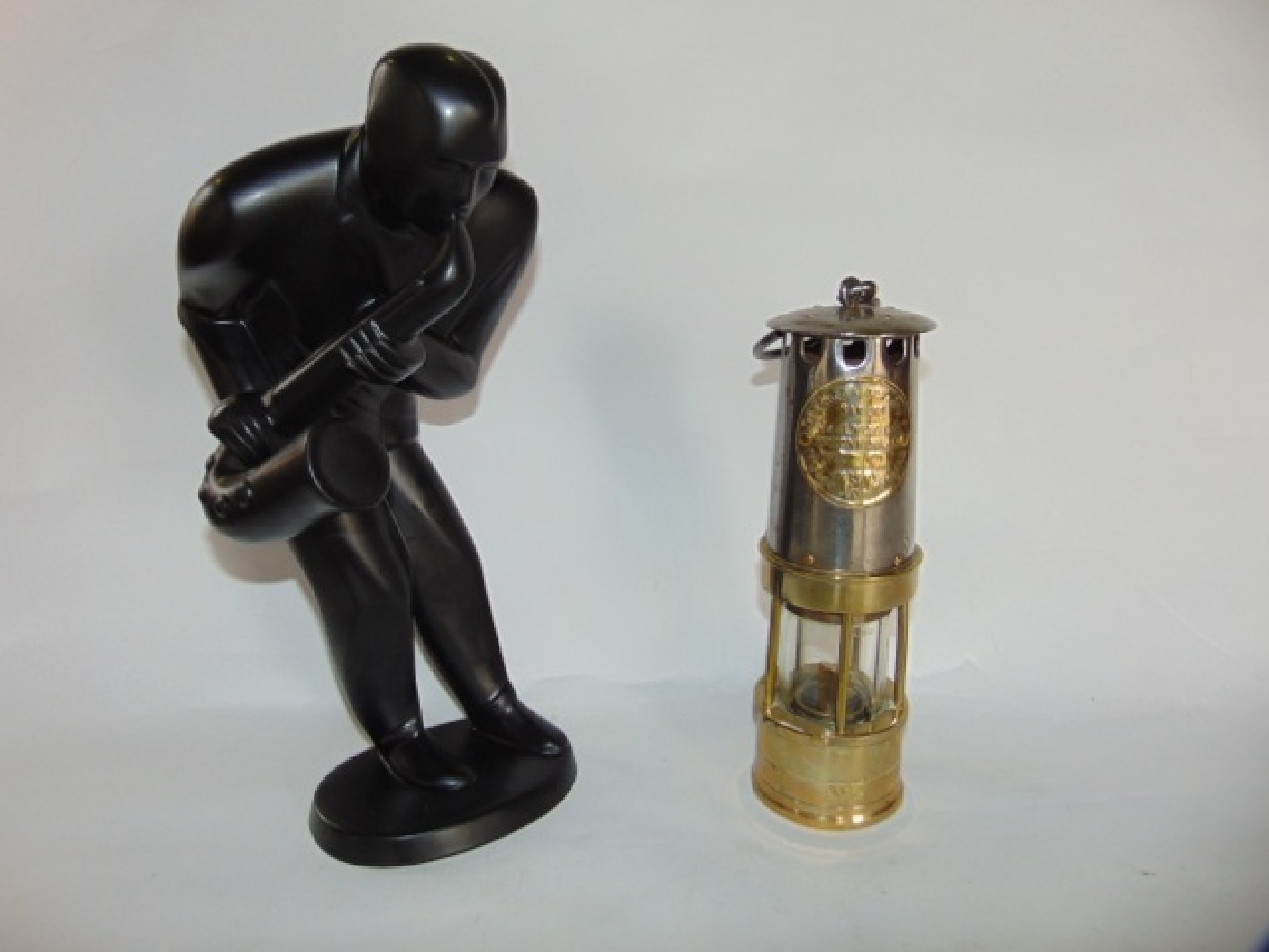 Appraisal: A brass and steel clad miner's lamp with applied label