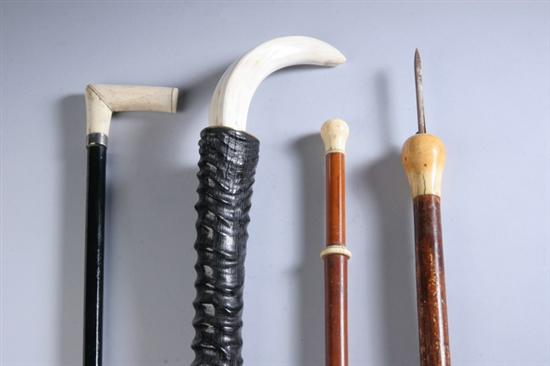 Appraisal: FOUR IVORY CANES One with boar's tusk over antler shaft