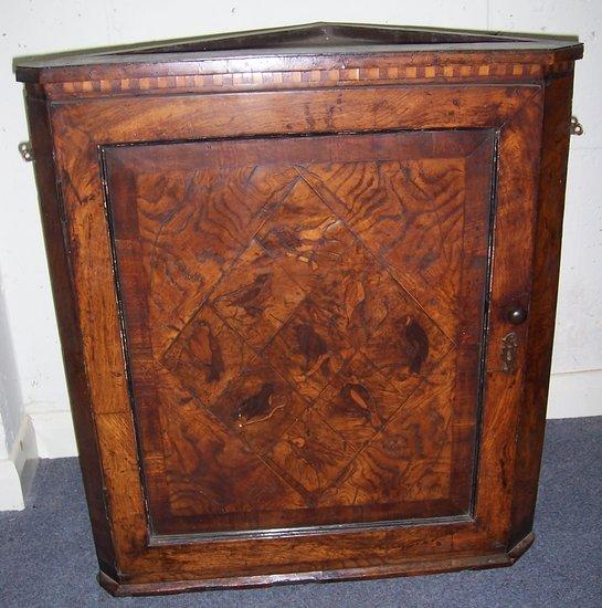 Appraisal: An th Century oak hanging corner cupboard the panel door