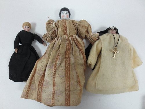 Appraisal: A porcelain doll with black moulded hair wearing breeches and