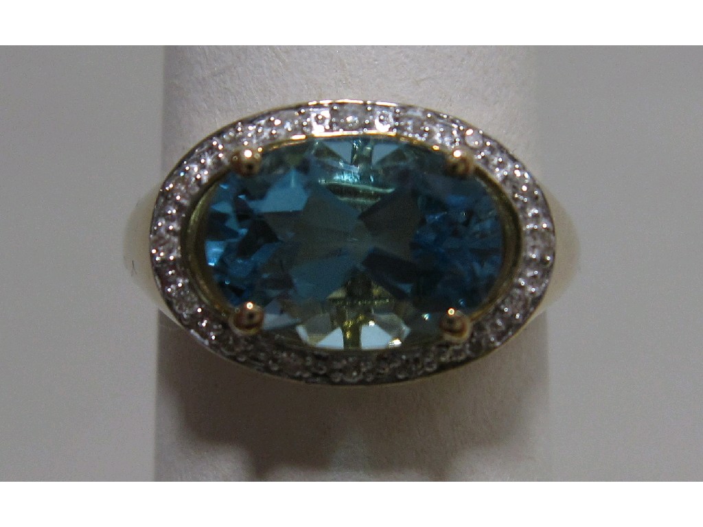 Appraisal: Nine carat gold blue topaz and diamond set dress ring