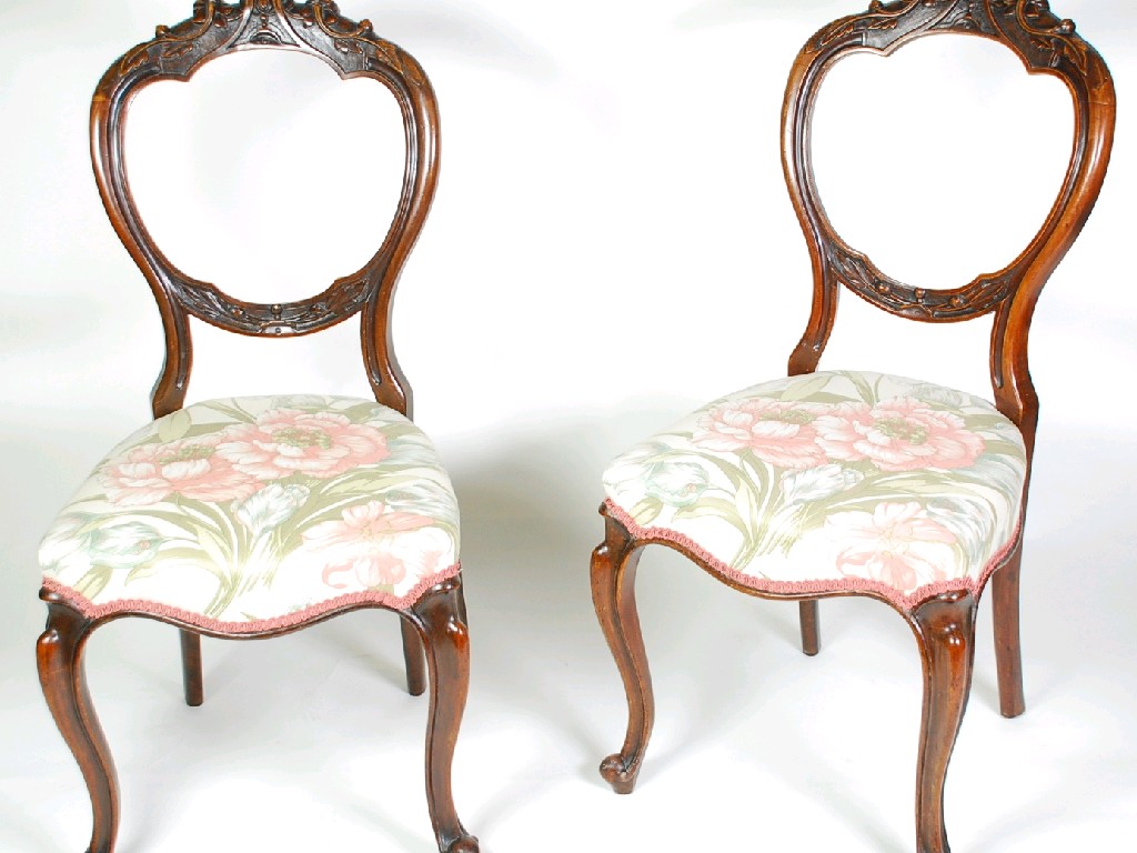 Appraisal: PAIR OF VICTORIAN CARVED WALNUT BALLOON BACK SINGLE CHAIRS with