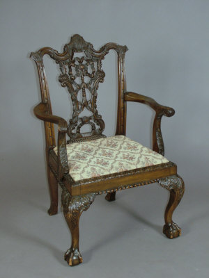 Appraisal: A Chippendale style heavily carved mahogany open armchair circa with