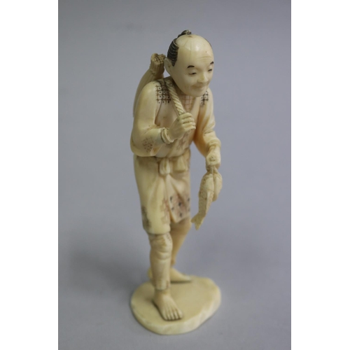 Appraisal: Japanese carved ivory figure fisherman signed to base approx cm