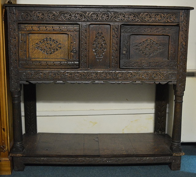 Appraisal: A th Century style carved oak livery cupboardwith planked under