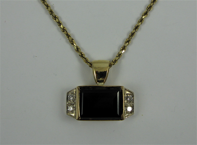 Appraisal: SMOKEY QUARTZ DIAMOND AND YELLOW GOLD NECKLACE The pendant is