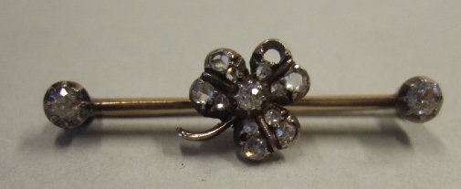 Appraisal: A diamond set bar brooch the centre with a clover