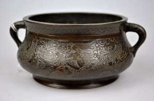 Appraisal: A Chinese bronze censer cast with panels of dragons phoenix