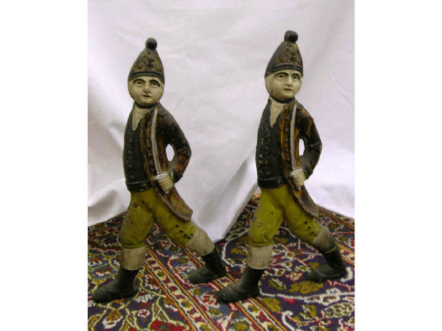 Appraisal: Pair of cast iron figural andirons depicting soldiers with swords