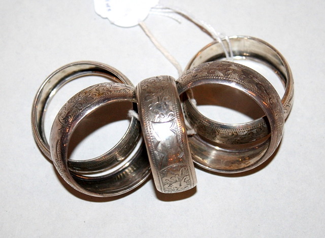 Appraisal: A SET OF FIVE SILVER NAPKIN RINGS with engraved scroll