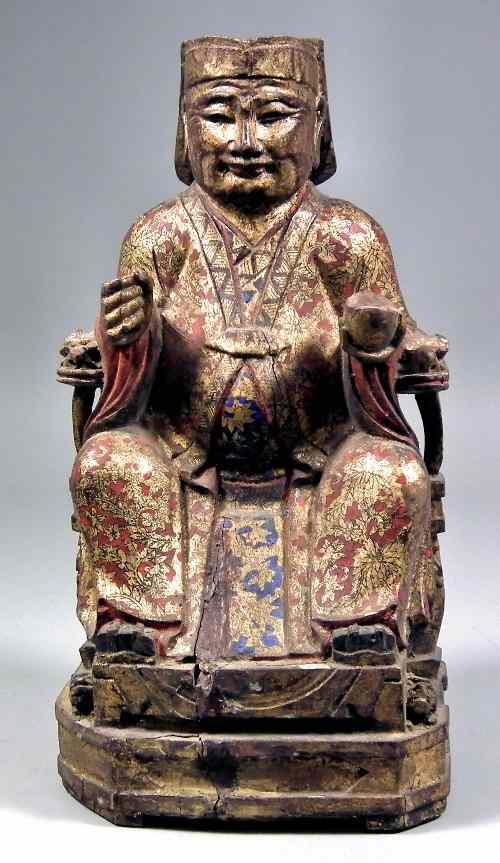 Appraisal: A Chinese lacquered and painted carved wood seated figure of