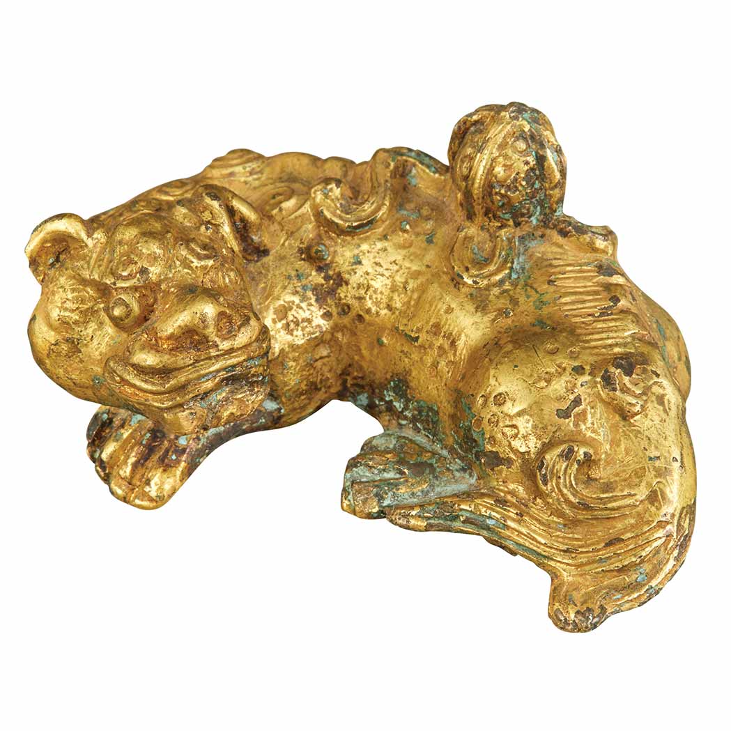 Appraisal: Chinese Gilt-Bronze Recumbent Lion Ming Dynasty The creature lying with