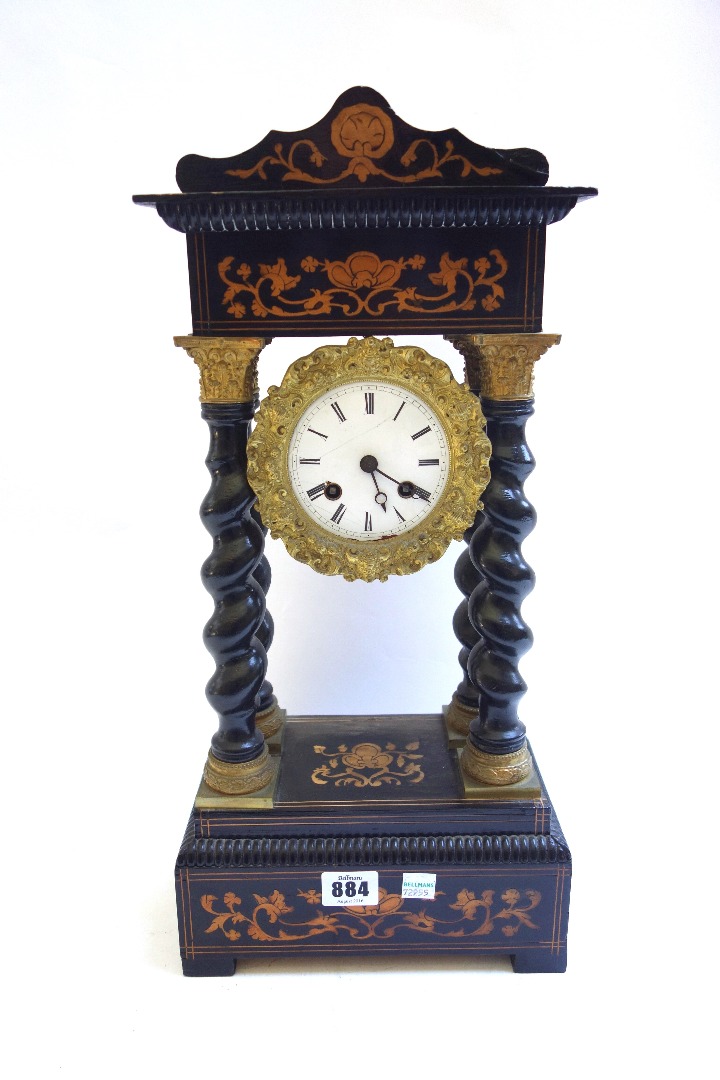 Appraisal: A French ebonised portico mantel clock th century with inlaid