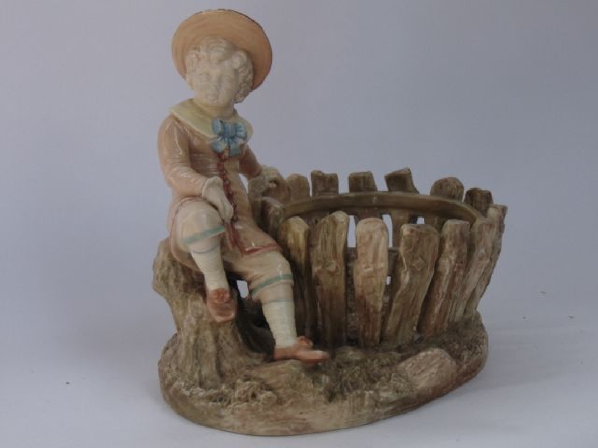 Appraisal: A Royal Worcester basket modelled as a young boy in