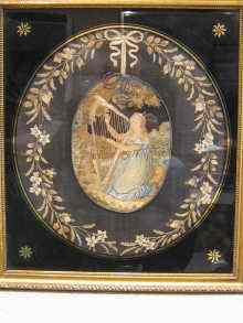 Appraisal: A needlework oval picture of a young harpist in original