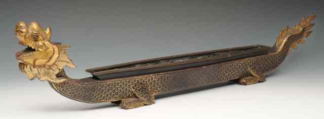 Appraisal: A TIBETAN CARVED WOOD DRAGON BOAT CLOCK with gilded and