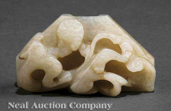 Appraisal: A Chinese Archaistic White Jade Dagger Fitting triangular form relief-carved