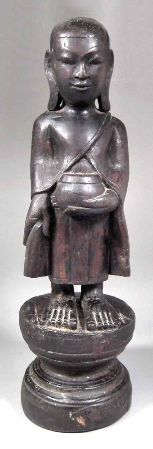 Appraisal: A Tibetan carved wood standing tomb figure - ''Begging Buddha''