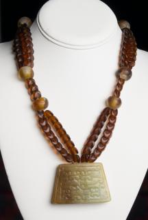 Appraisal: Carved Jade Pendant Necklace Double strand of brown matte finish