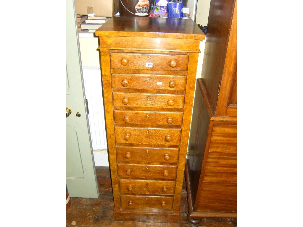 Appraisal: A walnut and figured walnut veneered Wellington chest fitted with