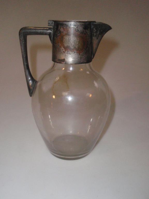 Appraisal: A Christopher Dresser designed claret jug with clear glass body