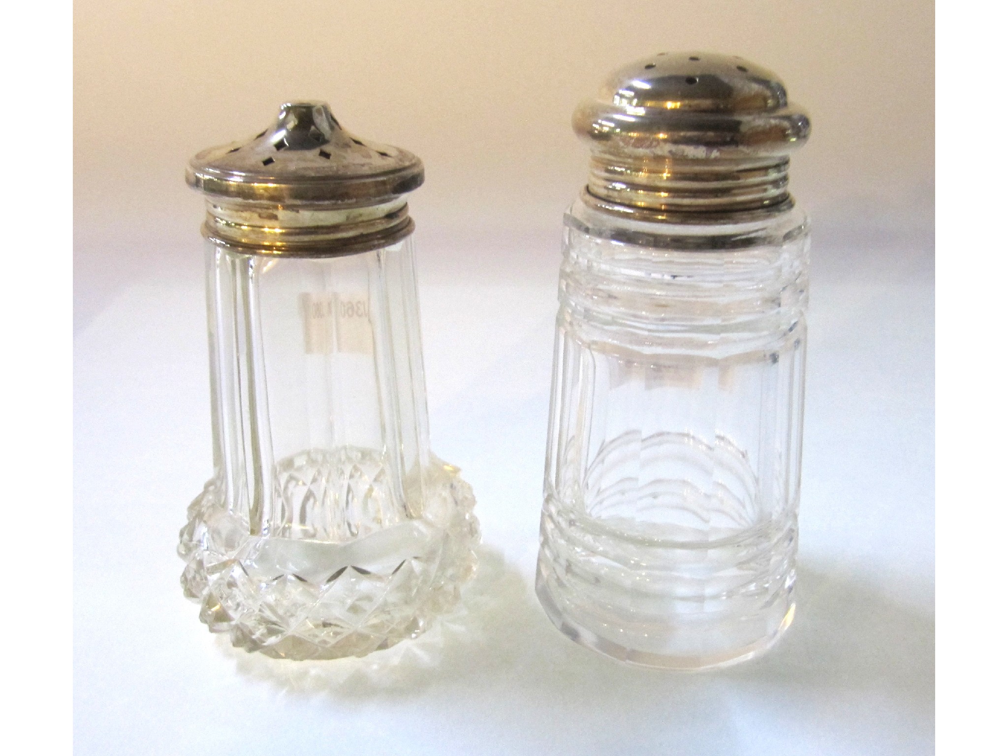 Appraisal: A lot comprising two silver topped glass sugar castors Birmingham