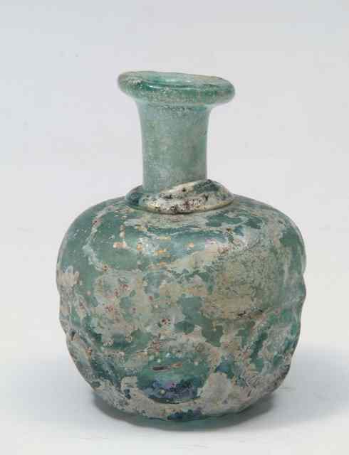 Appraisal: A PERSIAN NISHAPUR GREEN GLASS SMALL EWER with moulded and