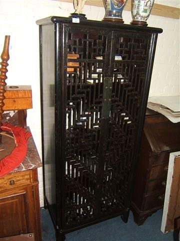 Appraisal: An Oriental black lacquered scroll cabinet wide