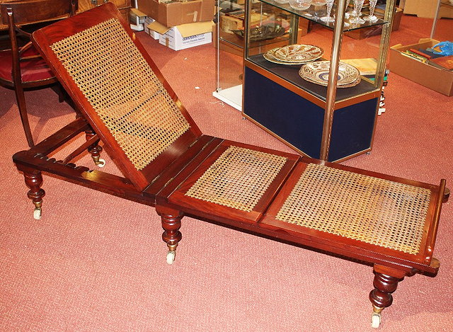 Appraisal: A VICTORIAN MAHOGANY FOLDING CAMPAIGN DAY BED with cane seat