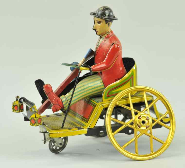 Appraisal: PAYA DRIVER IN RUNABOUT Spain lithographed tin figure has resemblance