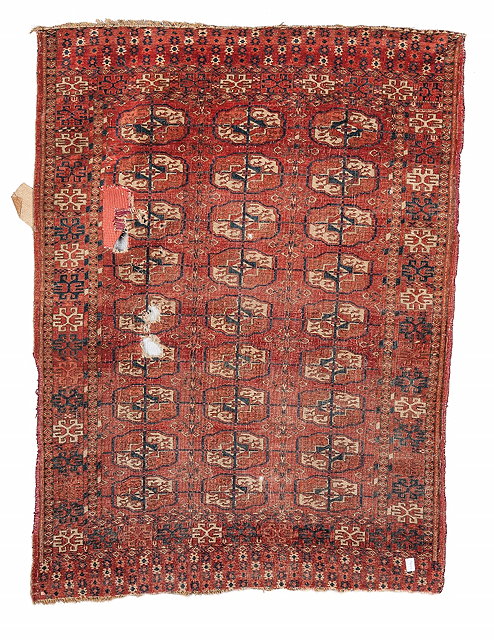 Appraisal: A CAUCASIAN FRAGMENT MAT with geometric decoration on a red