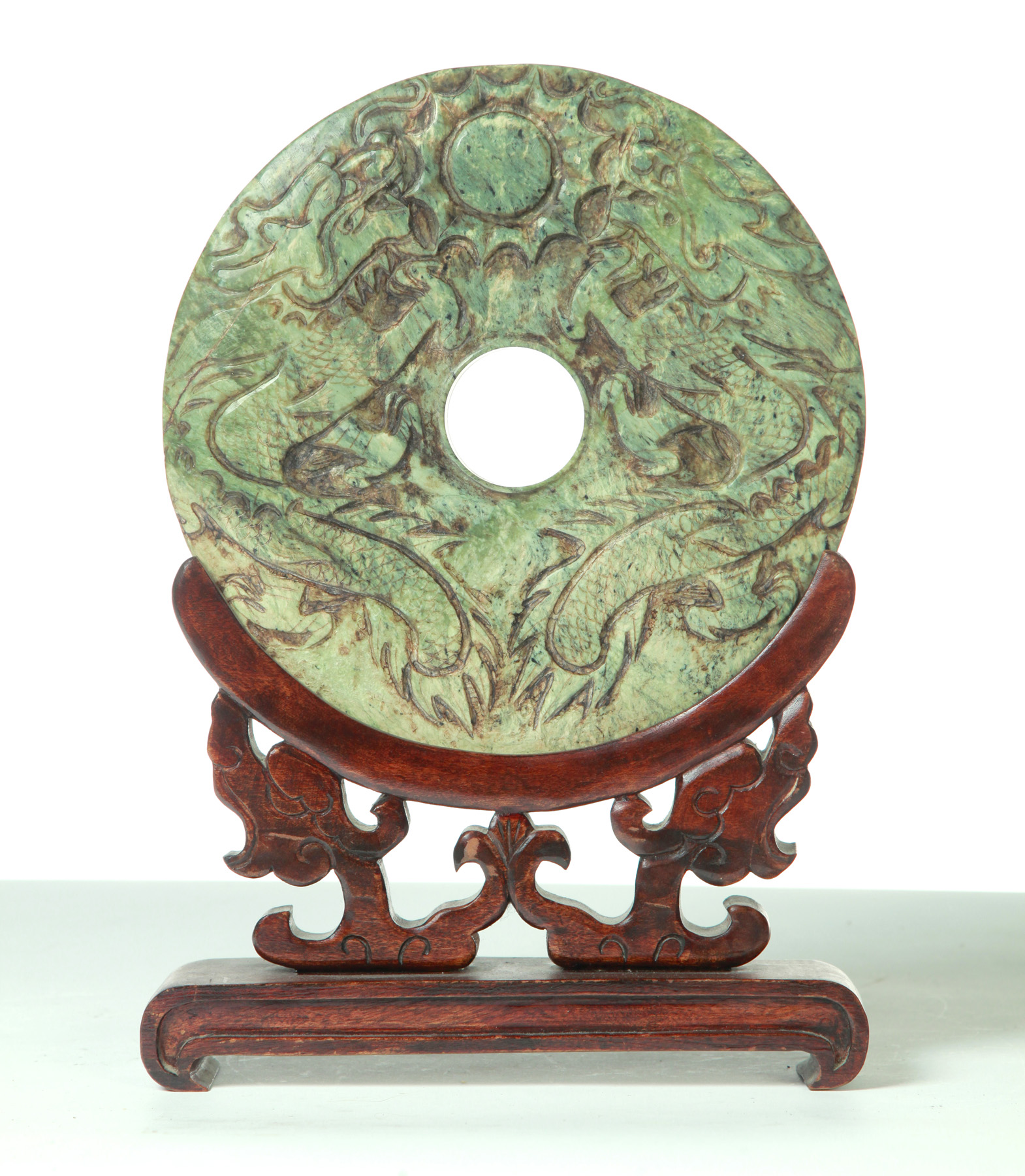 Appraisal: CARVED CHINESE DISK ON TEAK STAND Asian th century Soapstone