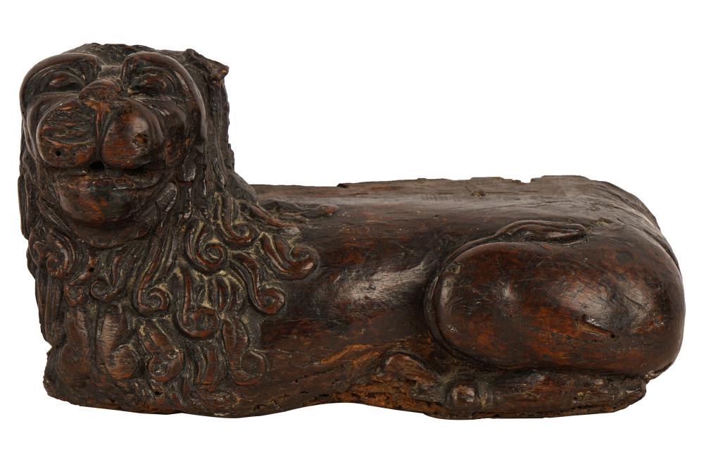 Appraisal: CARVED WOOD RECUMBENT LIONCondition with losses inherent with age beetle