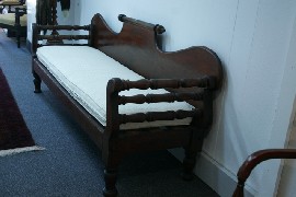 Appraisal: An Australian Colonial cedar miner's couch with rolling pin back