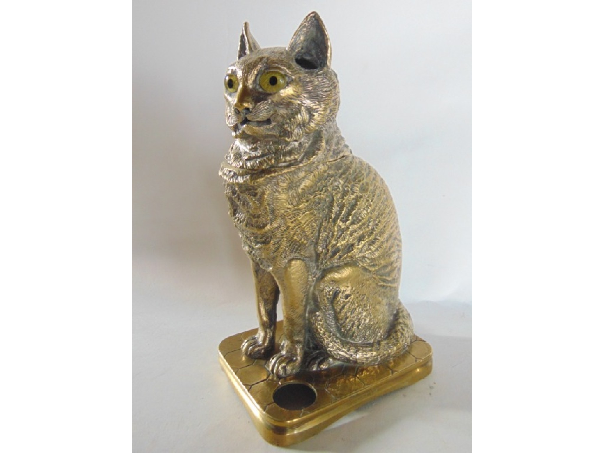 Appraisal: An unusual cast brass inkwell in the form of a