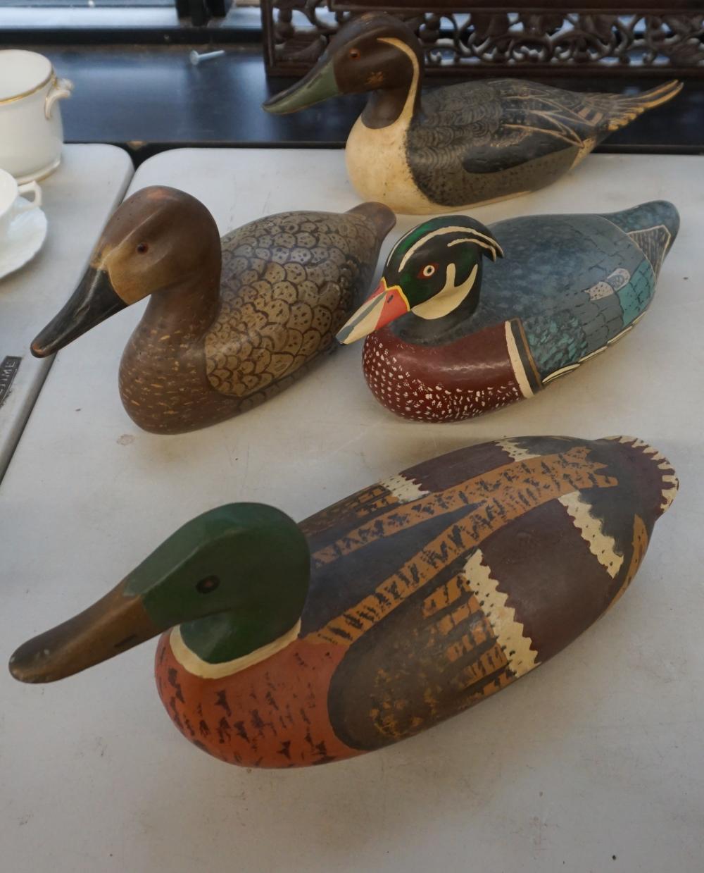 Appraisal: FOUR CARVED AND DECORATED WOOD DECOYS H OF LARGEST IN