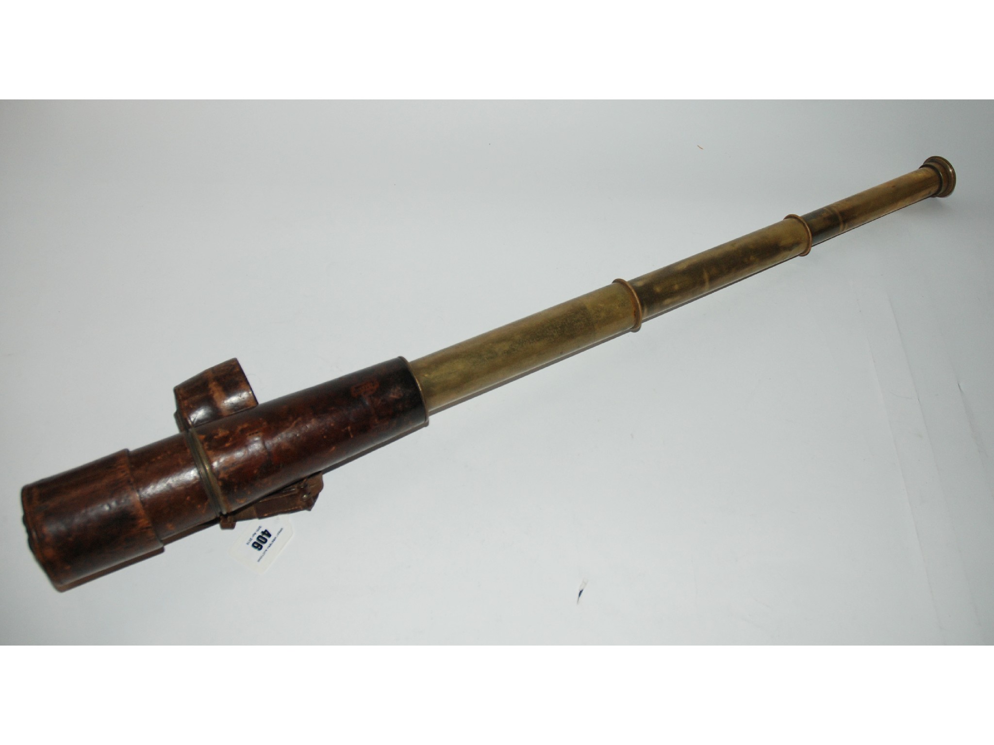 Appraisal: A brass military three draw telescope by TT H Ltd