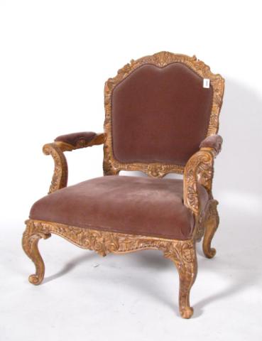 Appraisal: Period-style oversized armchair with heavily carved wooden frame cut velvet