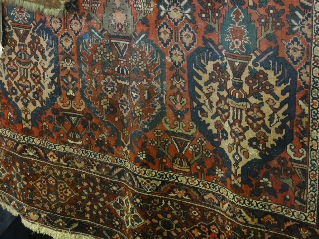 Appraisal: A large Middle Eastern carpet with three central medallions on