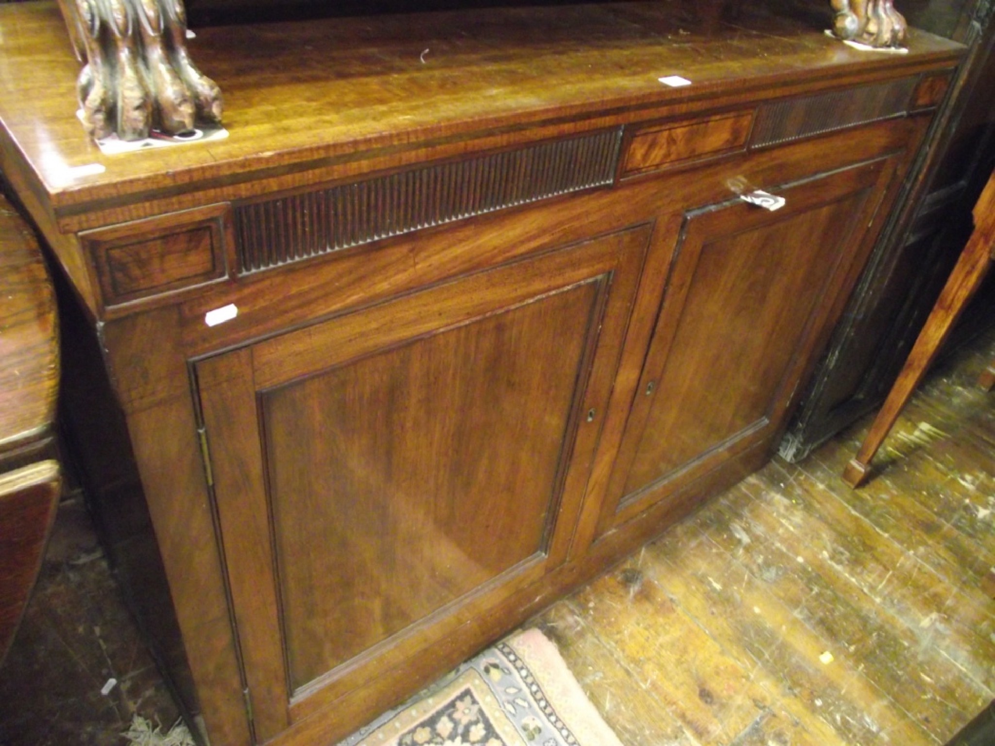 Appraisal: A Georgian mahogany side cupboard enclosed by two panelled doors