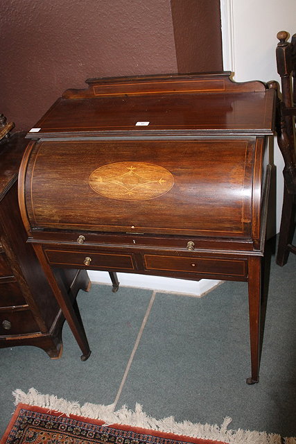 Appraisal: A SMALL EDWARDIAN MAHOGANY BUREAU the cylindrical door inlaid with